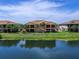 Exterior view of a lakefront home with a patio and beautiful landscaping at 7425 Divot Loop, Lakewood Ranch, FL 34202