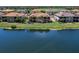 Exterior view of the home situated on a lake with a view of its rear patio at 7425 Divot Loop, Lakewood Ranch, FL 34202