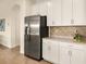 Bright kitchen with stainless steel refrigerator and white cabinets offering ample storage at 7425 Divot Loop, Lakewood Ranch, FL 34202