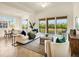 Bright living room inside of multi-Gathering home with tile floors and a beautiful view at 7425 Divot Loop, Lakewood Ranch, FL 34202