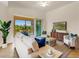 Bright living room in multi-Gathering home with tile floors and a stunning view at 7425 Divot Loop, Lakewood Ranch, FL 34202