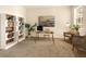 Well-lit home office with bookshelves, a glass-top desk, and comfortable seating at 7425 Divot Loop, Lakewood Ranch, FL 34202