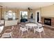 Outdoor kitchen and seating area features a fireplace, bar, and stainless steel grill at 7425 Divot Loop, Lakewood Ranch, FL 34202