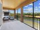 Screened-in patio with comfortable seating overlooking the scenic water view at 7425 Divot Loop, Lakewood Ranch, FL 34202