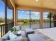 Relaxing screened patio with comfortable seating and a beautiful lake view at 7425 Divot Loop, Lakewood Ranch, FL 34202