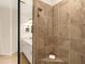 Close-up of a walk-in shower with gray tile and glass door showcasing bathroom vanity at 7425 Divot Loop, Lakewood Ranch, FL 34202