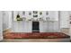 Wet bar features a beverage refrigerator, display cabinets, and neutral countertops at 78 Tidy Island Blvd, Bradenton, FL 34210