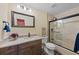 Well-lit bathroom features granite countertop, new fixtures, and a glass enclosed shower/tub at 78 Tidy Island Blvd, Bradenton, FL 34210