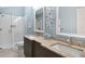 Modern bathroom with double sinks, granite countertop, framed mirrors, and glass shower at 78 Tidy Island Blvd, Bradenton, FL 34210
