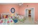 Bright bedroom featuring twin beds with colorful bedding, tile floors, and ceiling fan at 78 Tidy Island Blvd, Bradenton, FL 34210