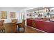 Dining area with a red bar, wine rack, and a mirrored shelf for drinks and glasses at 78 Tidy Island Blvd, Bradenton, FL 34210