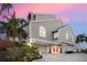 Stunning exterior of a multi-level home featuring modern architecture and lush greenery at 78 Tidy Island Blvd, Bradenton, FL 34210