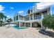 Exterior view of a home with a pool, patio, spiral staircase, and a well-maintained backyard at 78 Tidy Island Blvd, Bradenton, FL 34210