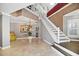 Elegant foyer with marble floors, chandelier, and staircase at 78 Tidy Island Blvd, Bradenton, FL 34210