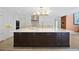 Spacious kitchen island featuring dark wood cabinetry, a white countertop, and stainless steel appliances at 78 Tidy Island Blvd, Bradenton, FL 34210