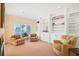 Bright living room with custom built-ins and water views through plantation shutters provides cozy comfort at 78 Tidy Island Blvd, Bradenton, FL 34210