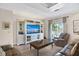 Cozy living room with built-in shelving, a plush leather couch, and natural light at 78 Tidy Island Blvd, Bradenton, FL 34210