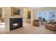 Charming living room featuring a cozy fireplace, elegant decor, and beautiful views of the bay at 78 Tidy Island Blvd, Bradenton, FL 34210