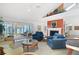 Bright living room with a fireplace, comfortable seating, and sliding doors to an outdoor deck with water views at 78 Tidy Island Blvd, Bradenton, FL 34210