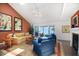 Bright living room with comfortable seating, a fireplace, and sliding doors to an outdoor deck with water views at 78 Tidy Island Blvd, Bradenton, FL 34210