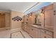 Elegant main bathroom featuring dual vanities, custom cabinetry, and high windows for natural light at 78 Tidy Island Blvd, Bradenton, FL 34210
