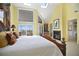 Bright main bedroom offering a cozy fireplace, stylish decor, and access to a private balcony at 78 Tidy Island Blvd, Bradenton, FL 34210