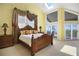 Elegant main bedroom with high ceilings, skylights, private balcony, and abundant natural light at 78 Tidy Island Blvd, Bradenton, FL 34210