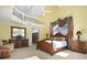 Spacious main bedroom with a decorative mirror, a seating area, and bright, sunny windows at 78 Tidy Island Blvd, Bradenton, FL 34210