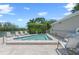 Outdoor spa with tiled patio, lush landscaping, and comfortable lounge chairs at 78 Tidy Island Blvd, Bradenton, FL 34210