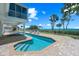 Relaxing pool area with a jacuzzi, patio, lounge chairs, and stunning backyard water views at 78 Tidy Island Blvd, Bradenton, FL 34210