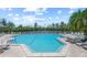 Large community pool with plenty of lounge chairs and beautiful landscaping at 78 Tidy Island Blvd, Bradenton, FL 34210