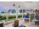 Bright sunroom with beautiful water views, comfortable seating, and overhead fan at 78 Tidy Island Blvd, Bradenton, FL 34210