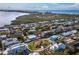 Scenic aerial view of the home and neighborhood with picturesque water views in the distance at 780 Jungle Queen Way, Longboat Key, FL 34228