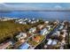 Gorgeous aerial view of this waterfront home and surrounding community with water views at 780 Jungle Queen Way, Longboat Key, FL 34228