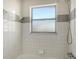 Cozy bathroom with clean, classic tile and a window, providing ample natural light at 780 Jungle Queen Way, Longboat Key, FL 34228