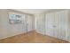 Bright, airy bedroom featuring bamboo flooring, neutral walls, and closet for ample storage at 780 Jungle Queen Way, Longboat Key, FL 34228