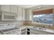 The kitchen has essential appliances and a window view of the outside at 780 Jungle Queen Way, Longboat Key, FL 34228
