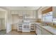 Bright kitchen with white cabinets and essential appliances ready for a homeowner's personal touches at 780 Jungle Queen Way, Longboat Key, FL 34228