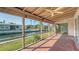 Enclosed porch featuring serene water views, perfect for relaxing and enjoying the outdoors at 780 Jungle Queen Way, Longboat Key, FL 34228