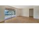 Bright living room featuring hardwood floors and access to the patio via sliding glass doors at 780 Jungle Queen Way, Longboat Key, FL 34228
