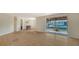 Spacious living room featuring hardwood floors and sliding glass doors with views of the canal at 780 Jungle Queen Way, Longboat Key, FL 34228
