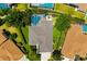 Aerial shot of home with pool, well-manicured lawn, and lush green surroundings at 7804 Edmonston Cir, University Park, FL 34201