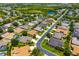 Aerial view of a residential community with lush greenery, tree coverage, and serene lakes at 7804 Edmonston Cir, University Park, FL 34201