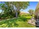 Beautiful backyard with lush landscaping, mature trees, and well-maintained lawn at 7804 Edmonston Cir, University Park, FL 34201