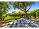 Lush backyard featuring a life-size checkerboard, mature trees, and well-maintained landscaping at 7804 Edmonston Cir, University Park, FL 34201