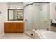 Bathroom with glass shower enclosure, vanity, and garden tub at 7804 Edmonston Cir, University Park, FL 34201