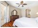 Bedroom with a ceiling fan, a dresser, and a sliding glass door at 7804 Edmonston Cir, University Park, FL 34201