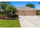 Well-maintained single-Gathering home with a three-car garage and beautifully landscaped front yard at 7804 Edmonston Cir, University Park, FL 34201