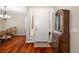 Inviting foyer with hardwood floors, decorative furniture, and a bright white front door at 7804 Edmonston Cir, University Park, FL 34201