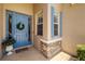 Charming home entrance with a decorative door and light blue window shutters at 7804 Edmonston Cir, University Park, FL 34201